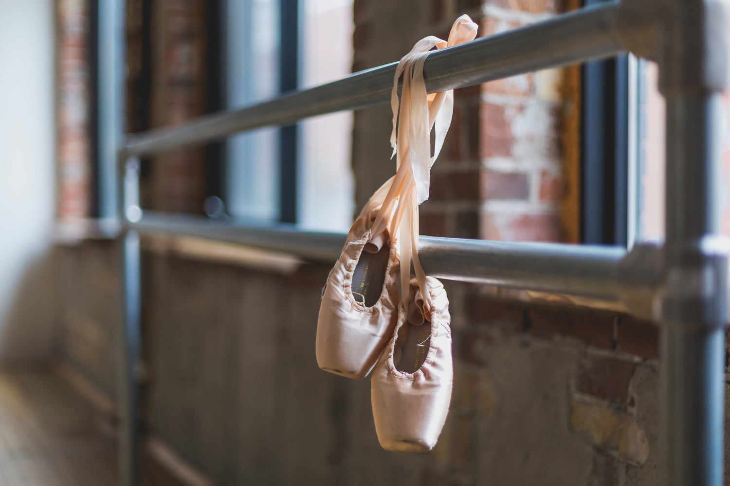Ballet Shoes hanging from dancing rail